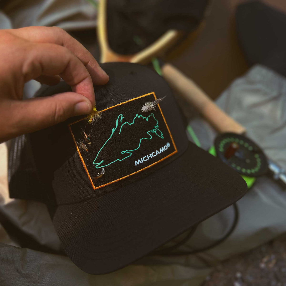 a person holding a hat with a hook on it
